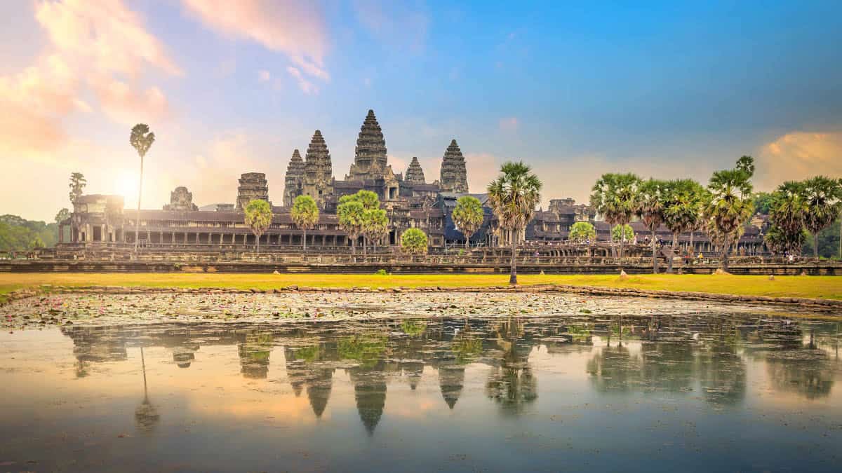 Hot-air balloon and pastel clouds beside Angkor Wat at Dawn with Balloon in Siem Reap, Cambodia.