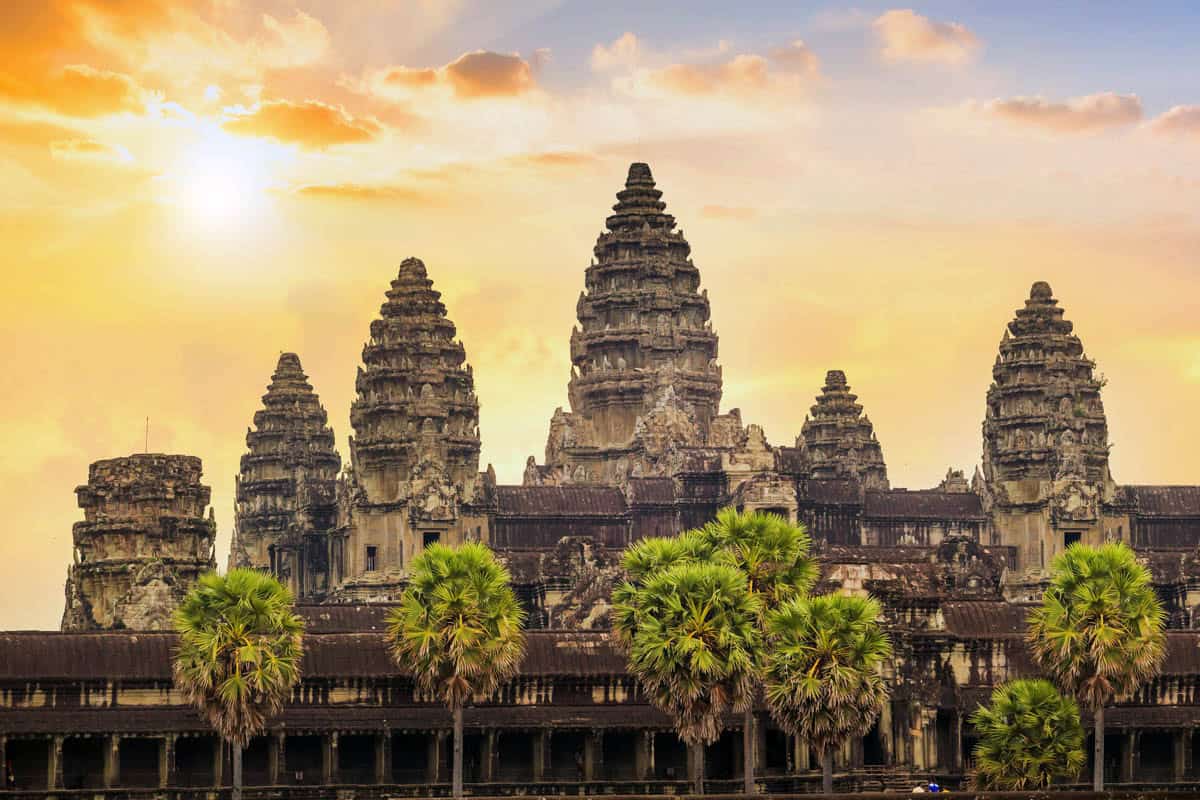Angkor Wat Central Towers amid stone causeway and warm sky in Siem Reap, Cambodia.
