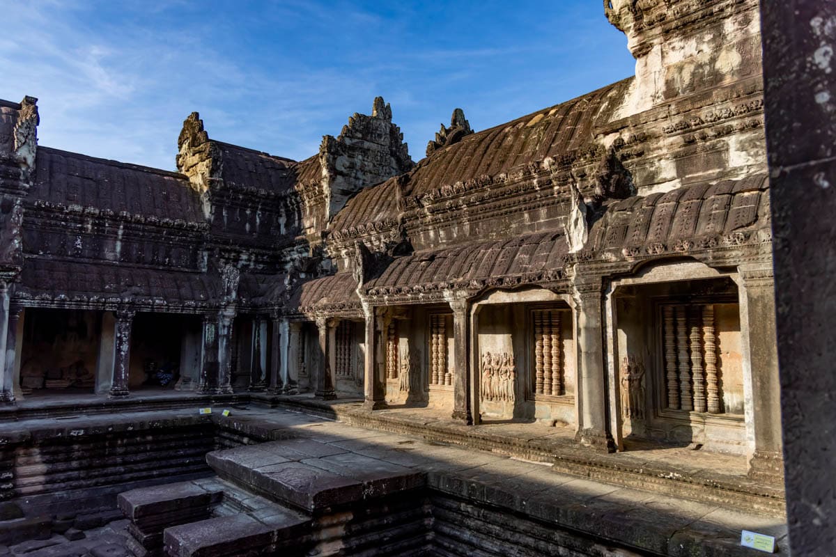 Angkor Wat Inner Gallery and Courtyard amid weathered sandstone walls and sunlit courtyard in Siem Reap, Cambodia.