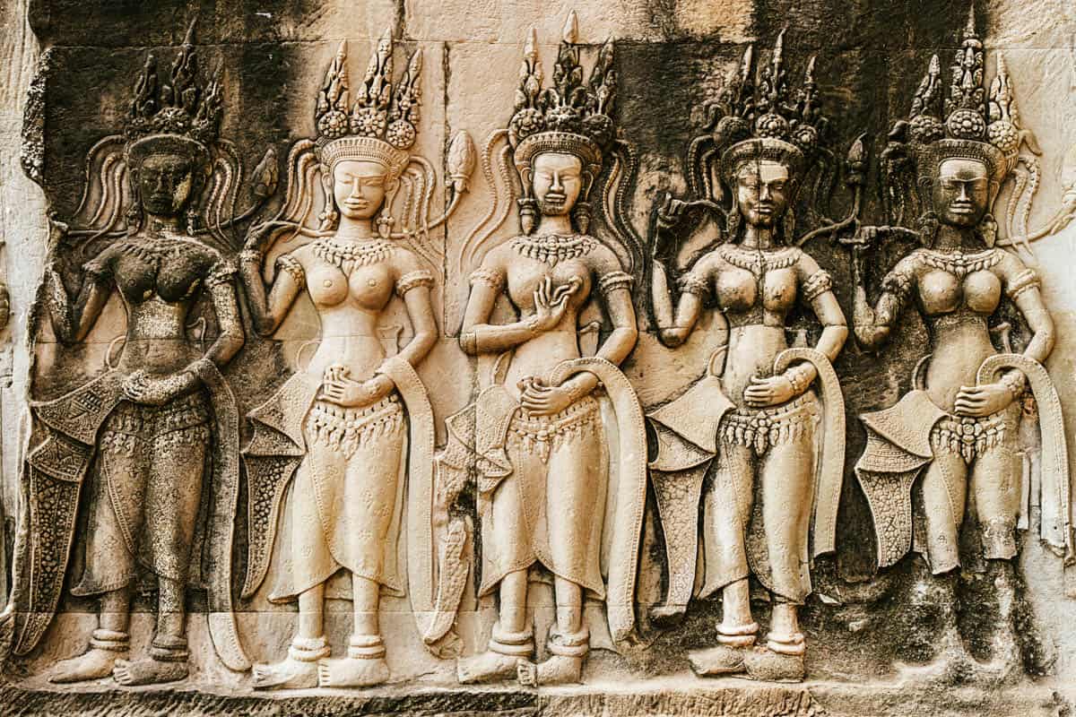 Ornate headdresses and jewelry beside Angkor Wat Apsara Relief in Siem Reap, Cambodia.